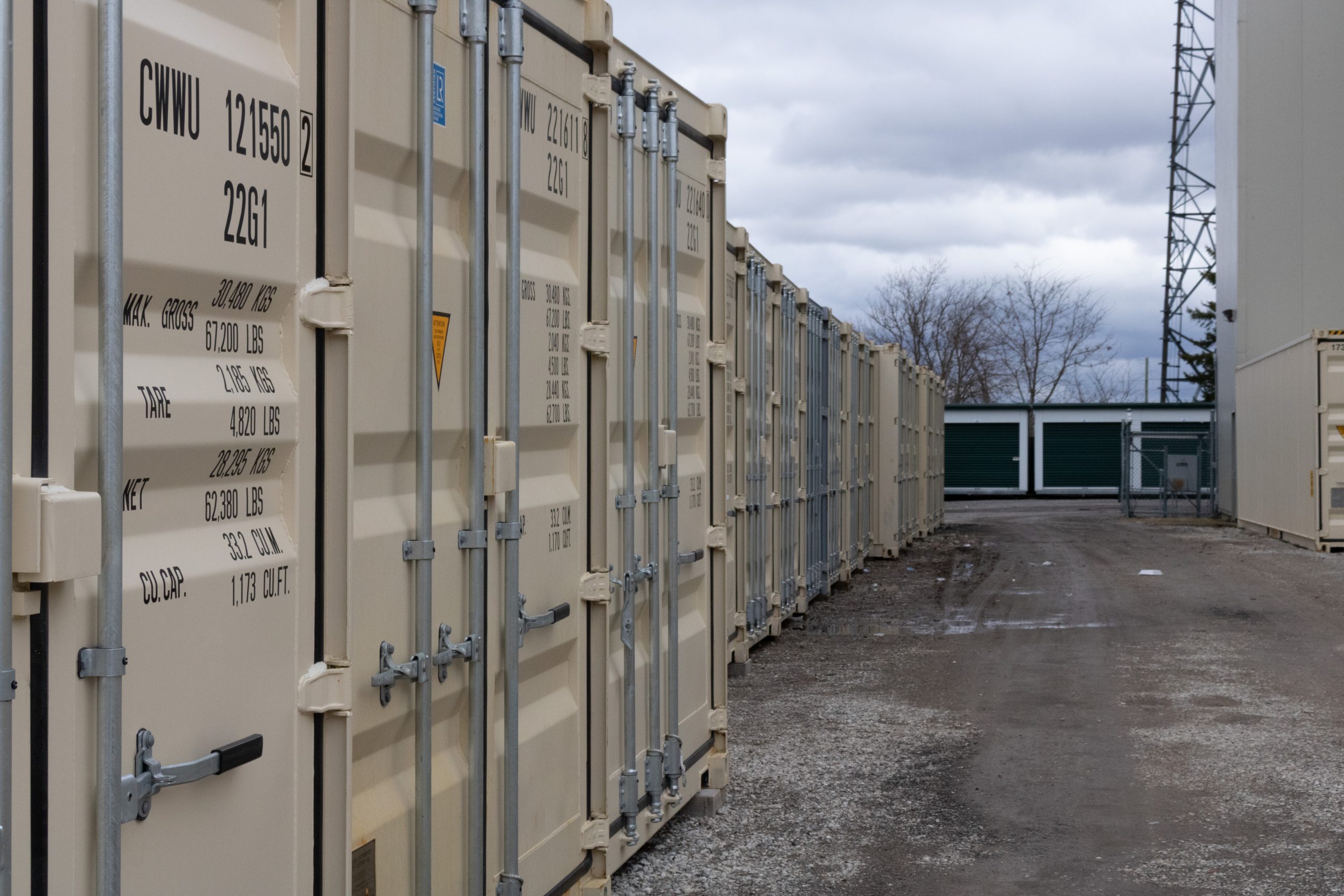 row of shipping containers used for storage leading to drive-up storage units