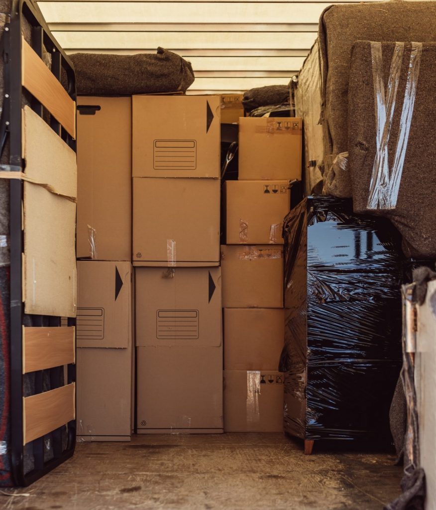 Full shot of a lot of boxes and packages from a move inside a truck
