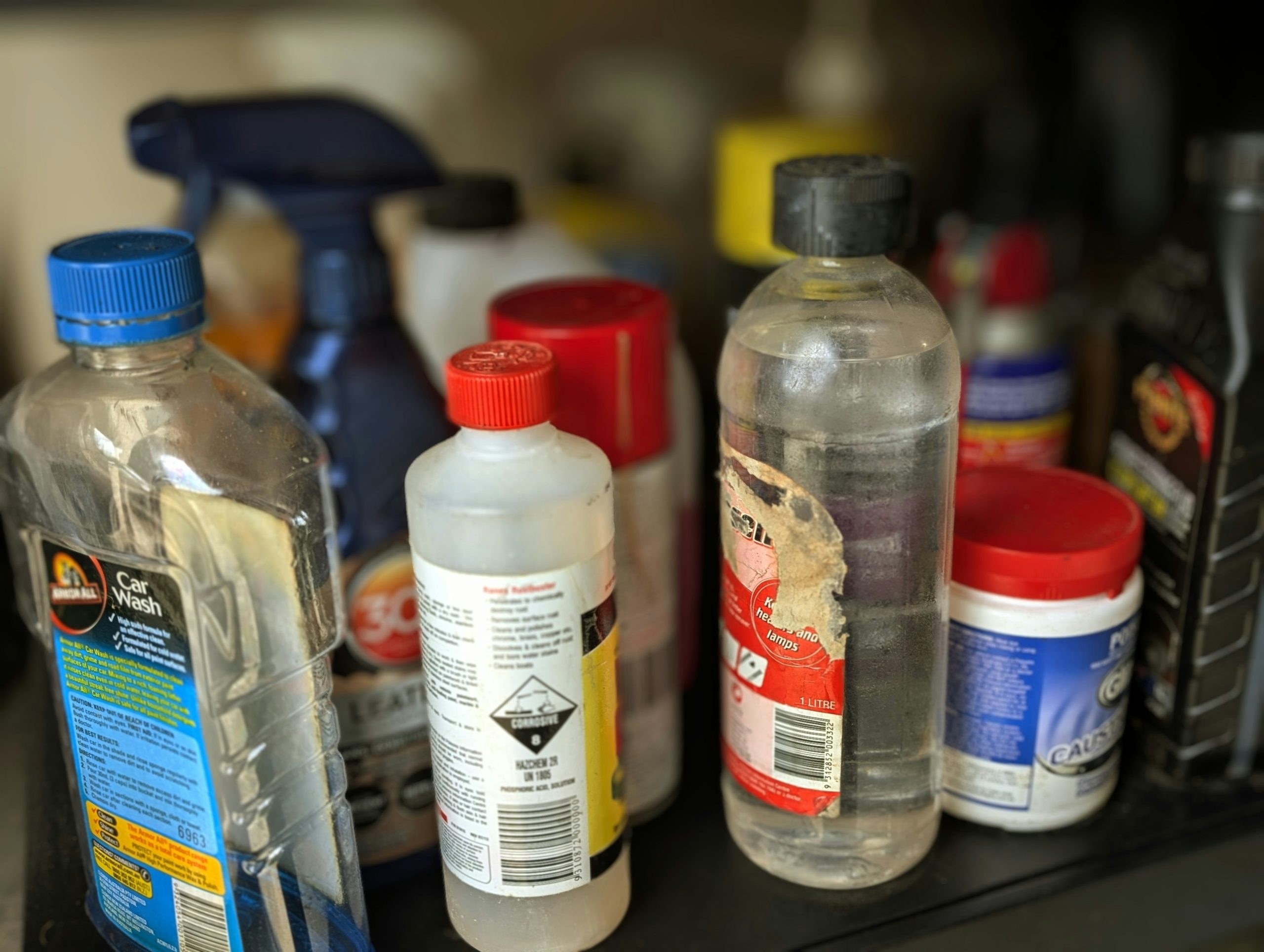 A shelf full of household chemicals that could be dangerous alone or together.