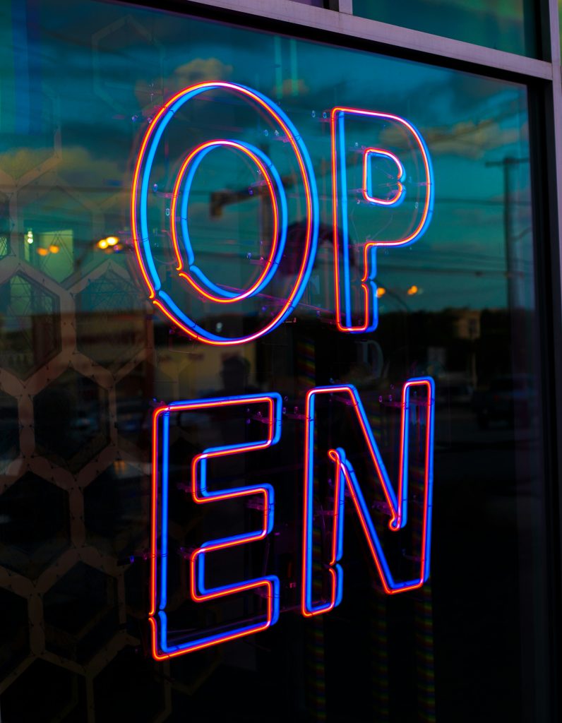 A neon sign that says open.